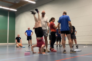 Carin ondersteboven in een workshop